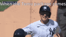 a new york yankees baseball player is running towards a base