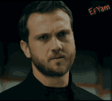 a close up of a man 's face with the name efyan written in red