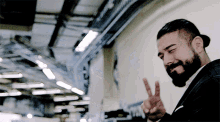 a man in a suit giving a peace sign