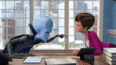 a woman sits at a desk talking to a cartoon character with the number 3 on his head