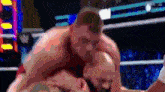 two men are wrestling in a ring and one of them has the letter w on his chest