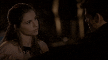 a man and a woman are looking at each other