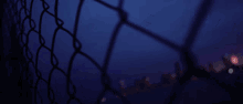 a blurry picture of a chain link fence with a glitch effect that says ' ec ' on it