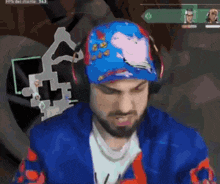 a man wearing a blue hat with a peppa pig design on it