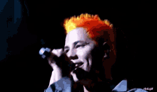 a close up of a person singing into a microphone with the words rbd.gif below them