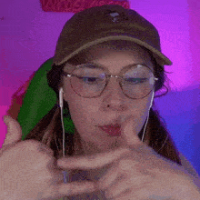 a woman wearing glasses and a hat with a snoop dogg logo on it