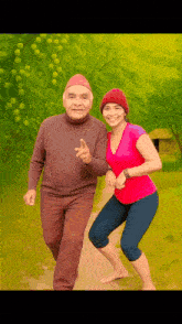 a man and a woman are posing for a picture and the woman is wearing a pink shirt