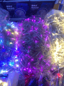 a bunch of purple lights are wrapped in clear plastic