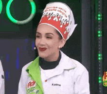 a woman wearing a chef 's hat and a chef 's jacket is smiling .
