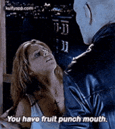 a woman is talking to a man in a leather jacket .