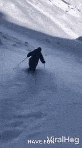 a person is skiing down a snow covered hill .