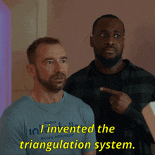 a man wearing a shirt that says i invented the triangulation system points to another man