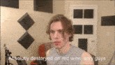 a man in a grey tank top is talking about red wine