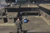 a screenshot of a video game shows a man standing in front of a building with a truck parked in front of it