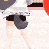 a girl with a wolf tail is dancing in front of a red balloon