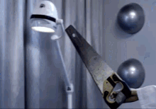 a person is holding a saw with the letter g on it