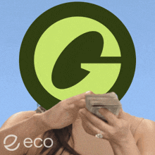 a woman holding a stack of money in front of a green g logo
