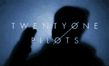 a twenty one pilots logo with a shadow of a person