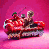 a woman is sitting on a red couch with a cherry on it