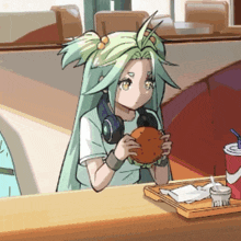 a girl with long green hair is eating a hamburger