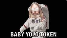 a man with a beard and glasses is wearing a space suit and says baby yolo token .