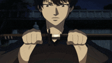 a man in a black shirt is holding a sword in his right hand