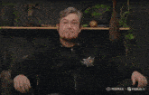 a man wearing a black hoodie with the word battle on it is making a surprised face