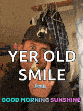 a man wearing a hat with a woman on it says yerold smile penis good morning sunshine