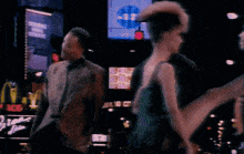 a woman in a green dress is dancing in front of a mcdonald 's sign