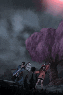 a man and a woman are standing in front of a tree with purple flowers