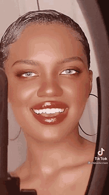 a close up of a woman 's face with a tik tok watermark