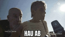 a man and a woman are talking into microphones and the woman says " hau ab "