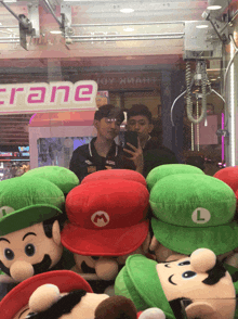two men are taking a picture in front of a crane sign