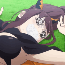 a girl is laying on the grass with a swirl around her eyes