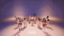 a group of women are dancing in front of a choom sign
