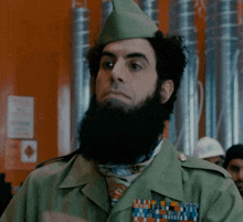a man with a beard is wearing a green hat