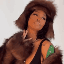 a woman wearing a fur hat and a fur coat .