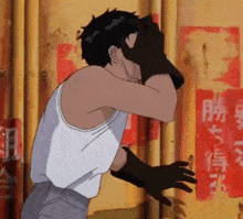 a man in a white tank top and black gloves is covering his face with his hands