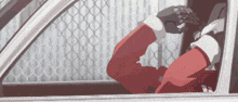 a man in a santa suit is sitting in a car looking out the window