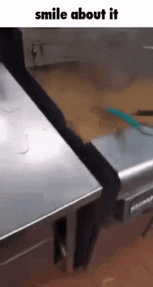 a stainless steel table with a brush on it and the words smile about it .