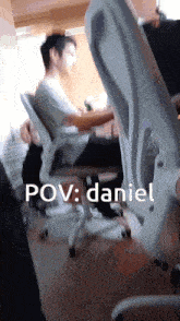 a man sits in an office chair with the words pov daniel written below him