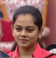 a woman in a red shirt is making a funny face .