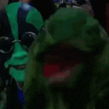 a couple of people with green face paint and sunglasses