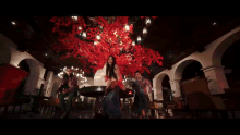 a woman is dancing in front of a fire and rain