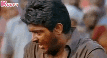 a close up of a man making a funny face in front of a crowd .