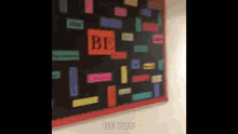 a bulletin board with a sign that says be you