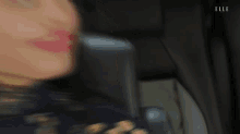 a woman sitting in a chair with her tongue hanging out and the word elle on the bottom