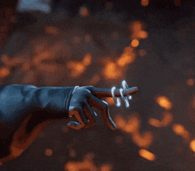 a close up of a person in a blue jacket holding a sword .
