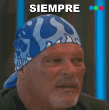a man wearing a blue bandana has the word siempre above him