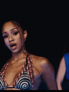 a woman wearing a braided ponytail and earrings has a ring on her finger that says always